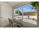 Bright enclosed lanai featuring tile floor, large windows, and view of landscaped backyard at 439 E Boyer St, Tarpon Springs, FL 34689
