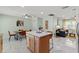 Open-concept living space featuring kitchen island, dining area, and comfortable living room at 439 E Boyer St, Tarpon Springs, FL 34689