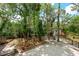A backyard setting with manicured flowerbeds and a small shed-like building near the rear of the property at 4701 Rambling River Rd, Brandon, FL 33511