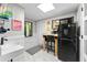Cozy bar area featuring a small island with seating, wet bar, and modern appliances at 4701 Rambling River Rd, Brandon, FL 33511
