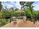 Relaxing deck area overlooking the river, with a table and chairs set for outdoor enjoyment at 4701 Rambling River Rd, Brandon, FL 33511