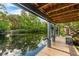 Dock on the river with a seating area, perfect for enjoying the tranquil water views at 4701 Rambling River Rd, Brandon, FL 33511
