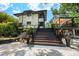 Landscaped home with brick paved walkway and elevated deck with staircase at 4701 Rambling River Rd, Brandon, FL 33511