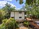 A modern home with lush landscaping and elevated deck at 4701 Rambling River Rd, Brandon, FL 33511