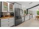 Well-equipped kitchen featuring stainless steel appliances, a large refrigerator and ample storage at 4701 Rambling River Rd, Brandon, FL 33511