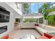 Bright, open living room featuring floor-to-ceiling windows, hardwood floors and modern furnishings at 4701 Rambling River Rd, Brandon, FL 33511