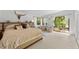 Bright main bedroom featuring sliding glass doors to an outdoor deck, decorative horns, and light wood flooring at 4701 Rambling River Rd, Brandon, FL 33511