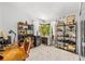 Home office space with natural light and hardwood flooring, and ample shelving for storage and display at 4701 Rambling River Rd, Brandon, FL 33511