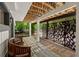 Inviting outdoor patio with a bench, pavers, unique metal screen, and lush landscaping at 4701 Rambling River Rd, Brandon, FL 33511