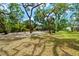 Lush, green yard featuring mature trees, providing a serene and private atmosphere at 4701 Rambling River Rd, Brandon, FL 33511