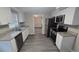 Well-lit kitchen featuring granite counters, stainless steel appliances, and white cabinets at 4750 Panorama Ave, Holiday, FL 34690