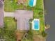 Aerial view of a home featuring a pool, canal access, and lush surrounding greenery at 5201 Dover Ne St, St Petersburg, FL 33703