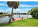 Waterfront property featuring a private wooden dock perfect for enjoying scenic views and canal access at 5201 Dover Ne St, St Petersburg, FL 33703