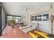 Inviting lanai with ceiling fan, tile flooring, and comfortable seating area overlooking the outdoor space at 5201 Dover Ne St, St Petersburg, FL 33703