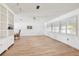 Bright and airy living room with hardwood floors, built-in shelving, and large windows at 5201 Dover Ne St, St Petersburg, FL 33703