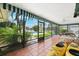 Enclosed patio with tile flooring, lounge furniture, and views of the pool and canal at 5201 Dover Ne St, St Petersburg, FL 33703