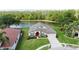 Beautiful single-story home situated on a lush green lot with scenic water views and a vibrant landscape at 5331 Villagebrook Dr, Wesley Chapel, FL 33544