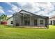 Enclosed back porch and patio area, excellent for entertaining or relaxing; spacious backyard at 5331 Villagebrook Dr, Wesley Chapel, FL 33544