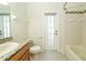 Well-lit bathroom with granite countertop, toilet, and shower/tub combo with decorative tile accents at 5331 Villagebrook Dr, Wesley Chapel, FL 33544