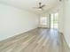 Spacious bedroom with hard surface flooring and a sliding glass door at 5331 Villagebrook Dr, Wesley Chapel, FL 33544