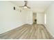 Bedroom features wood floors, a ceiling fan, and a walk-in closet at 5331 Villagebrook Dr, Wesley Chapel, FL 33544