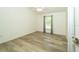 Light and airy bedroom with wood laminate floors, a window, and neutral-colored walls at 5331 Villagebrook Dr, Wesley Chapel, FL 33544