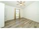 Bright bedroom featuring a ceiling fan, natural light from the window, and durable laminate flooring at 5331 Villagebrook Dr, Wesley Chapel, FL 33544