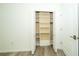 Bedroom closet with built-in shelving and ample storage space; freshly painted at 5331 Villagebrook Dr, Wesley Chapel, FL 33544