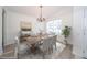 Bright dining room with wood floors, a rustic table, and a decorative chandelier at 5331 Villagebrook Dr, Wesley Chapel, FL 33544