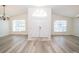 The bright entryway boasts wood floors, high ceilings, and a double-door entrance at 5331 Villagebrook Dr, Wesley Chapel, FL 33544