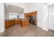 Kitchen showcases an island, granite countertops, stainless steel appliances, and tile floors at 5331 Villagebrook Dr, Wesley Chapel, FL 33544