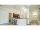 Open kitchen with bar seating, stainless appliances, and great natural light at 5331 Villagebrook Dr, Wesley Chapel, FL 33544