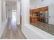 Open kitchen showcases stainless steel appliances and a view to the living area at 5331 Villagebrook Dr, Wesley Chapel, FL 33544