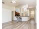 Open concept living area with wood floors, breakfast bar and view of the front door at 5331 Villagebrook Dr, Wesley Chapel, FL 33544