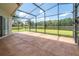 Enjoy the serene views from the screened-in lanai, featuring tile flooring and backyard access at 5331 Villagebrook Dr, Wesley Chapel, FL 33544