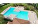 Aerial view of a large community pool featuring ample seating, meticulously maintained landscaping, and shaded areas at 5331 Villagebrook Dr, Wesley Chapel, FL 33544