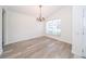 A well-lit room featuring wood flooring, a chandelier, and natural lighting at 5331 Villagebrook Dr, Wesley Chapel, FL 33544