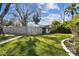 Well manicured backyard with grass and a bamboo fence for extra privacy at 610 N Woodlynne Ave, Tampa, FL 33609