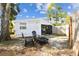 View of backyard featuring a seating area with chairs, fire pit and bamboo fence at 610 N Woodlynne Ave, Tampa, FL 33609