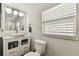 Bathroom featuring a modern vanity with drawers, stylish mirror, and toilet at 610 N Woodlynne Ave, Tampa, FL 33609
