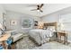 Comfortable bedroom with a leather chair, wood floors, and a ceiling fan at 610 N Woodlynne Ave, Tampa, FL 33609