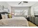 Cozy bedroom with a comfortable bed, soft lighting, and a large window with blinds at 610 N Woodlynne Ave, Tampa, FL 33609
