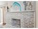 Close-up of the decorative white brick fireplace, art piece, and mantle at 610 N Woodlynne Ave, Tampa, FL 33609
