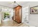 Hallway featuring an armoire and doorway into an adjacent bathroom at 610 N Woodlynne Ave, Tampa, FL 33609