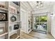 Well lit hallway with book shelving leading to an outdoor patio with furniture at 610 N Woodlynne Ave, Tampa, FL 33609