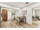 Spacious kitchen with wood-look flooring, white wainscoting, and a wooden table with stools at 610 N Woodlynne Ave, Tampa, FL 33609
