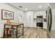 Bright kitchen with white cabinets, stainless steel appliances, and a wooden dining table at 610 N Woodlynne Ave, Tampa, FL 33609