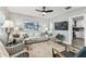 Bright living room with a ceiling fan, neutral decor, and stylish furnishings at 610 N Woodlynne Ave, Tampa, FL 33609