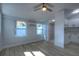 Bright living room with laminate floors leads into a bathroom and kitchen space at 610 N Woodlynne Ave, Tampa, FL 33609