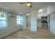 Bright living room with laminate floors leads into a bathroom and kitchen space at 610 N Woodlynne Ave, Tampa, FL 33609
